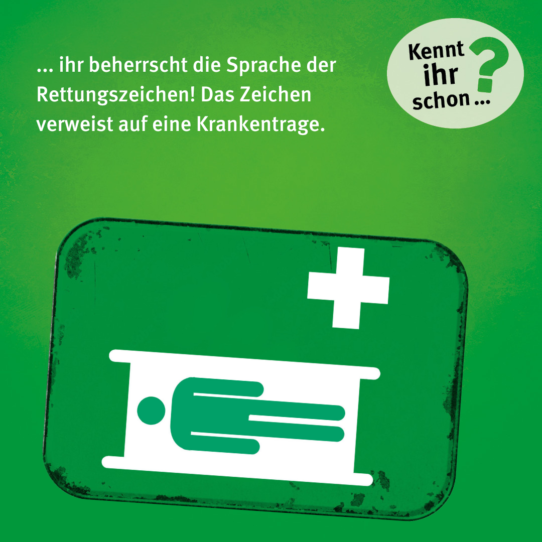 ... ihr beherrscht die Sprache der Rettungszeichen! Das Zeichen verweist auf eine Krankentrage. Das Zeichen besteht aus einem weißen Kreuz und einer Person, die unterhalb davon auf einer weißen Trage liegt.